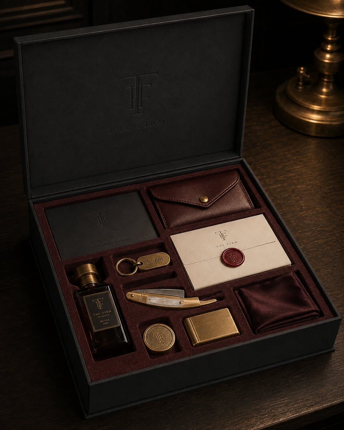 The welcome box, open: card, pouch, sealed letter, cologne, keyring, razor, token, matches and pocket square